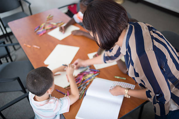 Teacher supporting students in a special education classroom.